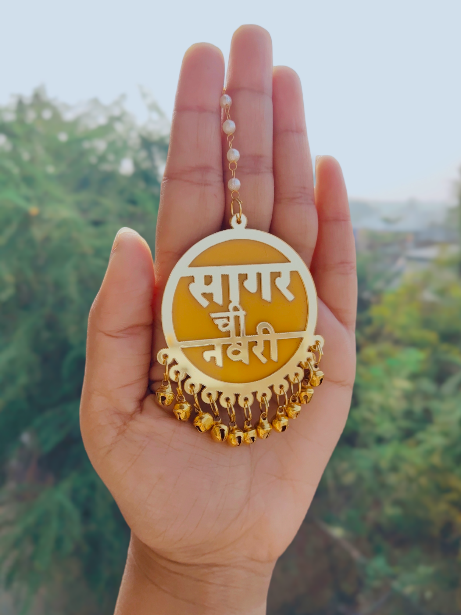Vibrant yellow Dulhaniya maang tiika capturing intricate detailing and personalized text in Hindi and Marathi, exemplifying superb craftsmanship and cultural opulence